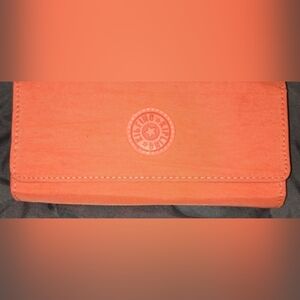 Kipling Coral-Orange Canvas Clutch with Embossed Round Logo